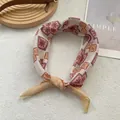 Pink and orange geometric silk scarf with bohemian floral patterns on soft white fur - Ethnic Yellow