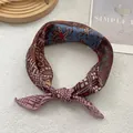 Detail of vintage paisley cotton linen scarf featuring colorful floral patterns and stitching - Coffee Totem