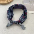 Detailed close-up of navy blue paisley floral square scarf with rolled hem edges - Navy Totem