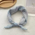 Detail of floral chiffon scarf with elegant lace patterns and soft blue pastel tones - Milk Blue Floral