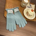 Detail of light blue knit gloves with delicate pointelle lace and ruffled wrist cuffs - Lake Blue