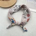 Detailed close-up of vintage floral cotton linen neckerchief with delicate hemmed edges - Exotic