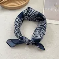 Detail view of the navy blue floral pattern on a lightweight silk square scarf texture - Navy Garden Floral