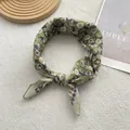 Detail of vintage floral cotton linen scarf with green base and purple flower patterns - Green