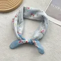 Detail of light blue floral cotton linen scarf with red blossoms and navy border - Blue
