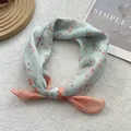 Close-up of floral cotton linen neckerchief with mint green and orange dual-tone design - Small Flower Orange