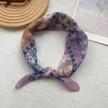 Detailed view of soft purple paisley cotton linen scarf on white plush background - Pink