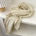Detail of beige cotton linen shawl with crinkle texture and wavy lettuce edge hem - 230x57cm / Beige
