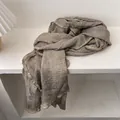 Detailed view of brown-grey crinkle fabric scarf with ruffled edges and soft texture - 230x57cm / Flaxen
