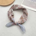 Detail of checkered silk scarf showing stitching edges and soft fabric texture on plush - 58x58 / Coffee