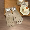 Close-up of khaki knit gloves with diamond hollow patterns and scalloped cuffs - Khaki