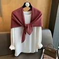 Close-up of white cotton top styled with a burgundy polka dot shawl on a wooden hanger - Burgundy
