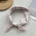 Detail showing pink floral silk scarf with bow tie and vertical stripe texture - Pink