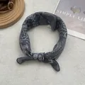 Close-up of dark grey paisley pattern fabric headband with ethnic geometric floral prints - Large Square / Navy Blue