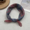 Detailed view of bohemian style ethnic print silk headscarf in dark blue and red patterns - One Size / Red