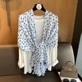 White linen scarf with blue heart patterns and navy tassels worn over a white top - 180*70cm / Blue