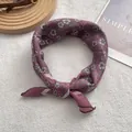 Detail of burgundy floral silk neckerchief tied in a loop on a lifestyle background - 58cm x 58cm / Wine Red Floral (4)