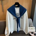 100% Australian wool knit shawl over a grey Northwestern University graphic sweatshirt - Blue