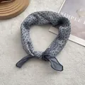 Detailed close-up of grey-blue floral scarf tied in a knot on a soft white fabric surface - 58cm x 58cm / Grey Blue Edge Floral (7)