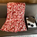 Detail of red leaf pattern with gold foil edges on a lightweight summer silk scarf - 180*70cm / Red