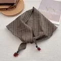 Detailed view of vintage plaid scarf featuring cotton-linen texture and tassel edges - Coffee