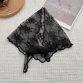 Black lace triangle headscarf with floral embroidery and wavy edges in a flat lay view - Black