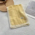 Bufanda de lino amarillo pálido con borde de encaje blanco y etiqueta de marca minimalista - Amarillo Queso