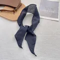 Detail of navy blue linen skinny scarf on white grid background with simple life decor - Navy Blue