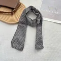 Close-up of grey floral linen scarf with scallop lace edges and diamond patterns - Gray Diamond Grid