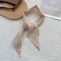 Macro detail of beige handmade linen scarf with woven label on waffle fabric background - Off White