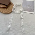 Detailed close-up of white lace ribbon featuring exquisite rose floral embroidery patterns - Rose / 75x4cm