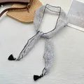Detail of floral skinny scarf with black tassels on white waffle texture background - Black and White Line Floral (1)