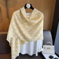 Close-up of elegant yellow polka dot scarf draped over a white blouse in a chic setting - Yellow Polka Dots