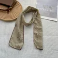 Detail of vintage floral cotton linen scarf with scalloped edges on minimalist background - Khaki Lavender