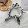 Polka dot paisley silk scarf in black and white tied in a bow on a waffle texture - 70x70cm / White