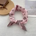 Detail of pink silk scarf with paisley pattern on white waffle texture and minimalist decor - 70x70cm / Pink
