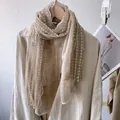 Elegant beige cotton linen scarf with white lace trim and dotted embroidery on a wooden hanger - Flaxen