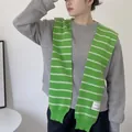 Close-up of green and white striped knit shawl featuring a decorative woven brand label - Tops / Green Double White Stripes / 42x100cm