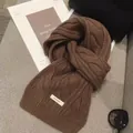 Close-up of brown thick cable knit wool scarf with 100% wool label and textured details - 170*30cm / Coffee