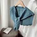 Detail of cable knit pattern and long straps on a dusty blue decorative shawl - Lake Blue