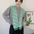 Detail of green and white striped knit shawl layered over a casual grey sweatshirt - Tops / Green & White Wide Stripes / 42x100cm