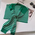 Detail of green and white striped knit shawl accessory on white table background - Forest Green