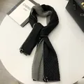 Detail of two-tone linen scarf featuring pleated texture and pom-pom fringe charms - Black/Grey Patchwork / Black