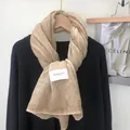 Khaki tie-dye crinkled cotton linen scarf with woven label hanging on wood hanger - Off White