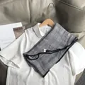 Detail of a black and white gingham cotton scarf paired with a white Peter Pan collar shirt - Black