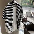 Detail of soft black and white striped 100% wool knit shawl layered over a white top - Black & White Stripe