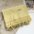 Detail of 100% Australian wool scarf in bright yellow featuring soft textured tassels - 180*30cm / Creamy Yellow