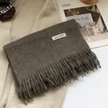 Detail of 100% Australian wool scarf with tassels and composition label on a coat - 180*30cm / Mocha Coffee