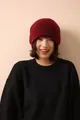 Detail view of the fine knit texture and soft dark red 100% wool material on this winter beanie - Red