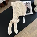 Detail of chunky knit cable pattern on ivory Balaclava with metal logo tag - Off White